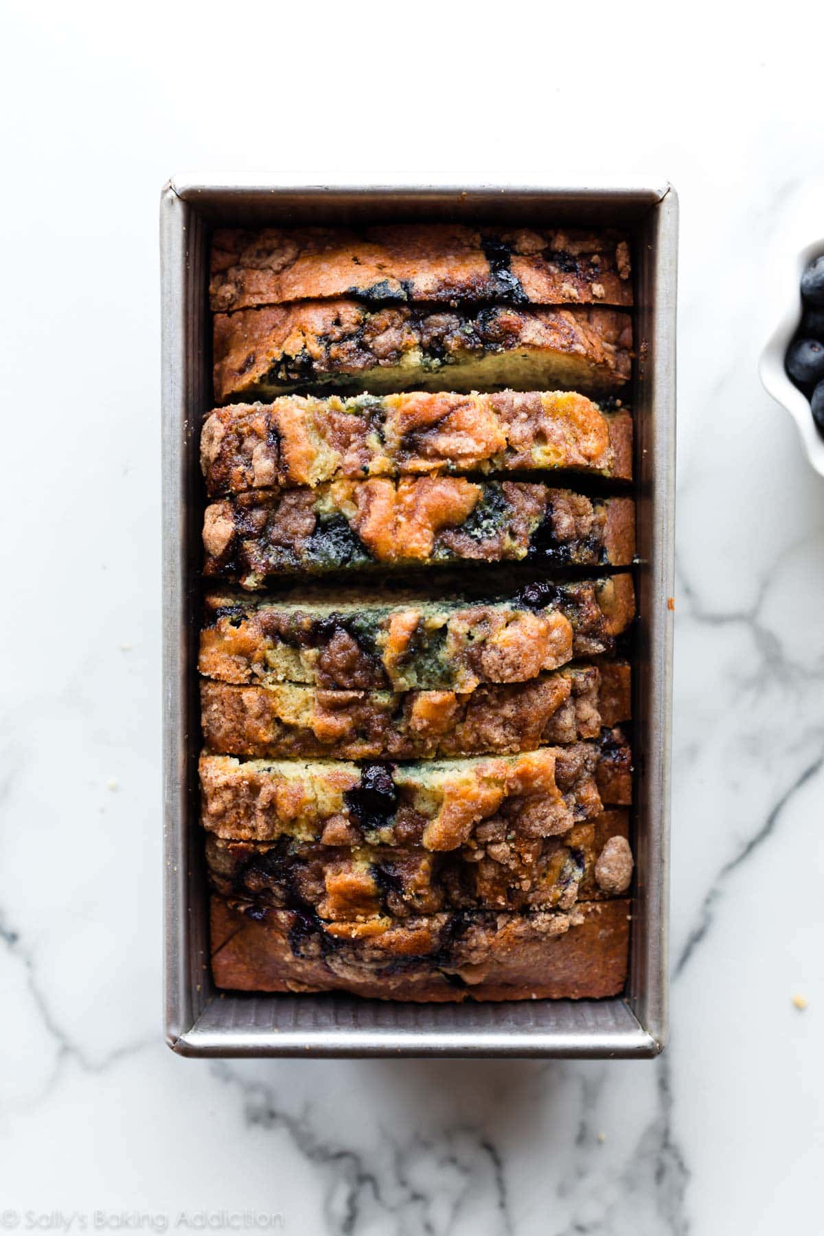 overhead image of blueberry muffin bread in loaf pan