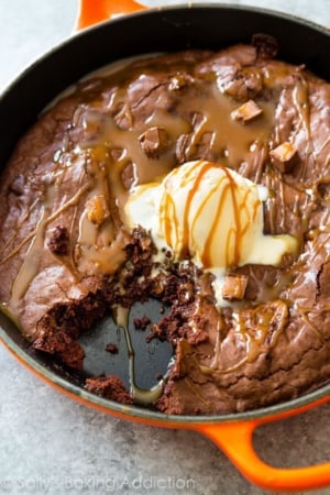 skillet brownie topped with ice cream and caramel sauce