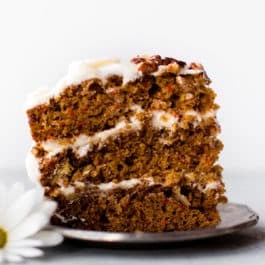 slice of carrot cake with cream cheese frosting on a plate