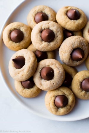 overhead image of peanut butter blossoms on a white plate