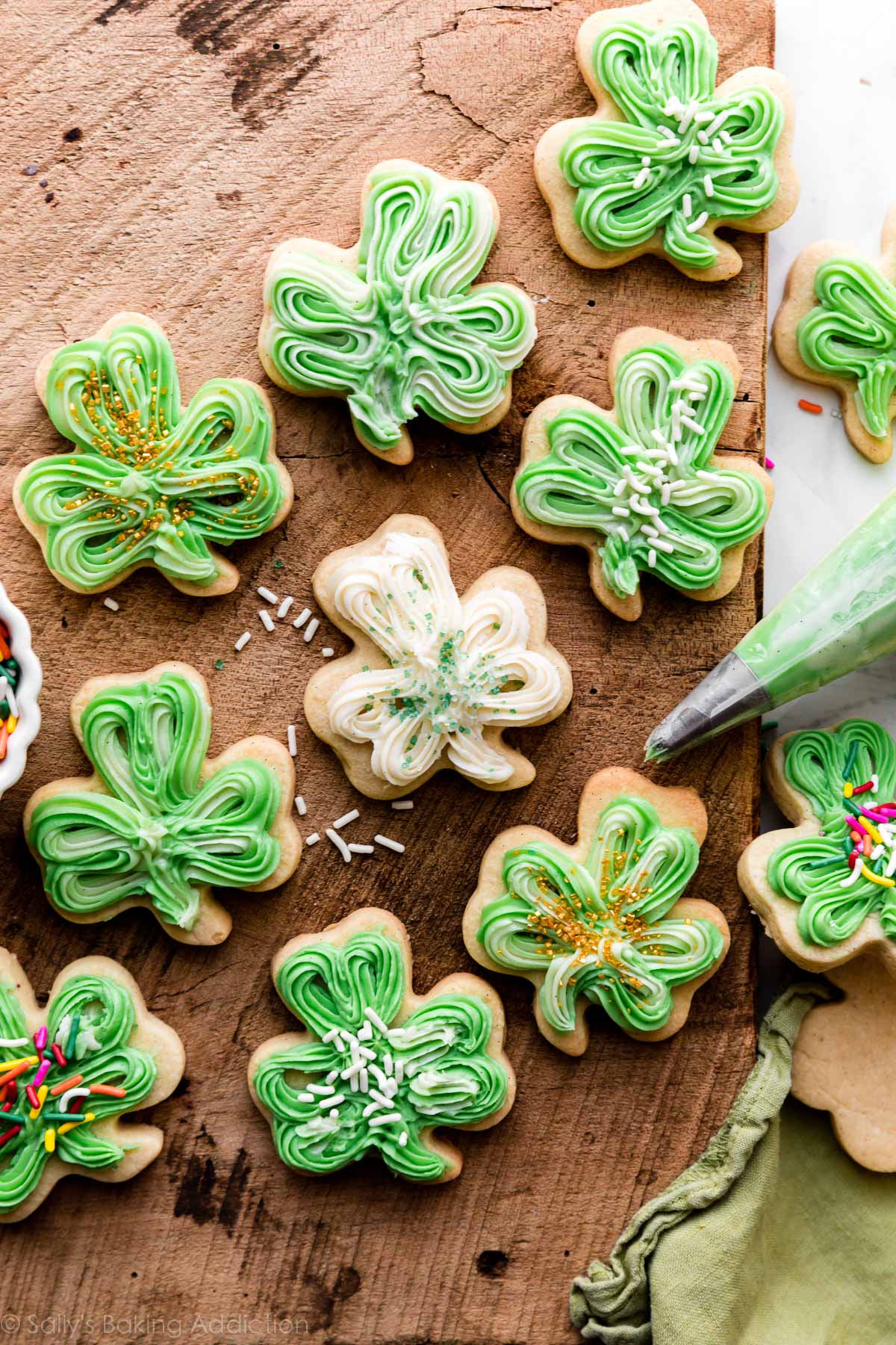 shamrock sugar cookies with green and white buttercream frosting